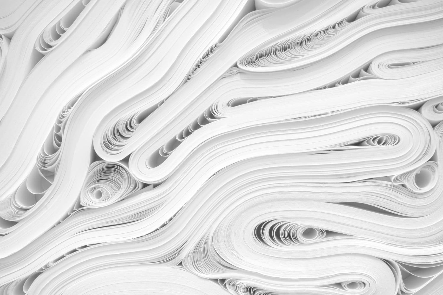 white paper stacked on top of each other with bends in the paper